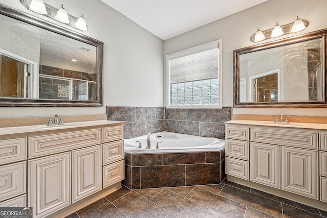 6722 Blue Heron Way, Flowery Branch, GA 30542 - full bathroom with two vanities, a garden tub, a shower stall, and vaulted ceiling