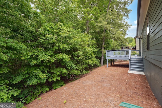 6722 Blue Heron Way, Flowery Branch, GA 30542 - view of yard featuring a wooden deck and stairs