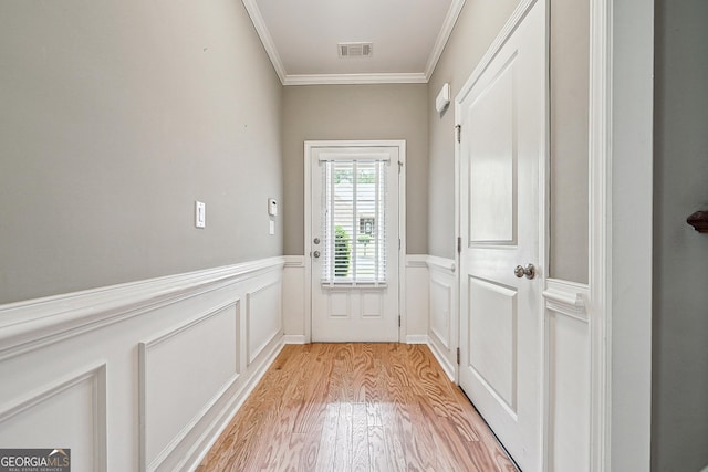 6722 Blue Heron Way, Flowery Branch, GA 30542 - entryway featuring ornamental molding, light wood finished floors, a wainscoted wall, and a decorative wall