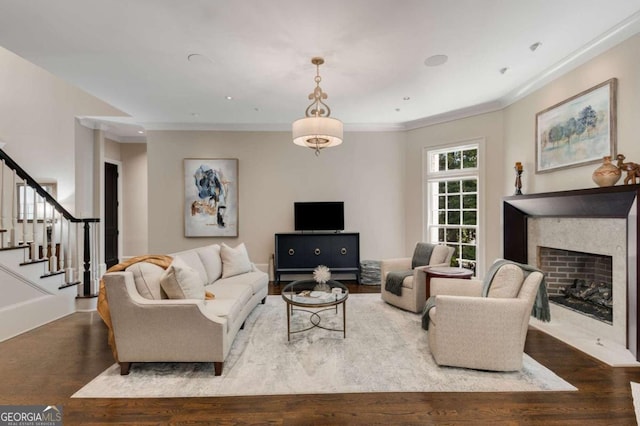 2375 Hyde Park Ct NW, Atlanta, GA 30318 - living area with wood finished floors, a fireplace with flush hearth, stairs, and ornamental molding