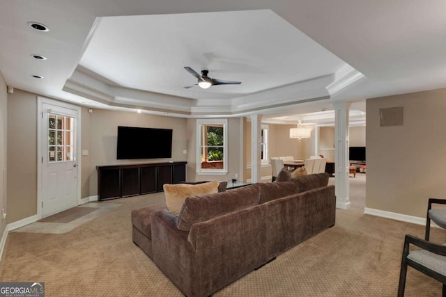 2375 Hyde Park Ct NW, Atlanta, GA 30318 - living area featuring ornate columns, a raised ceiling, light carpet, a ceiling fan, and healthy amount of natural light