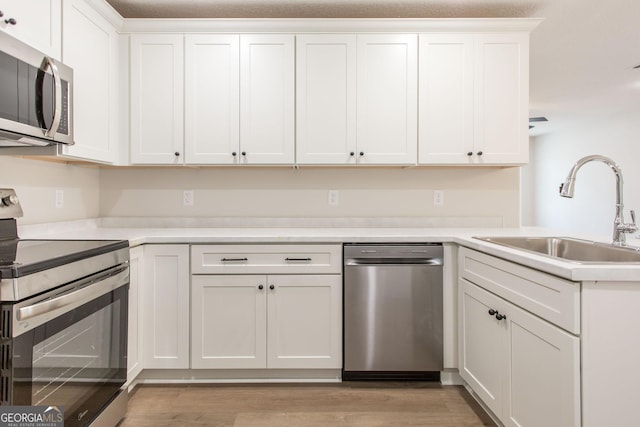1920 Darling Ave, Waycross, GA 31501 - kitchen featuring stainless steel appliances, light countertops, light wood-style flooring, and a peninsula