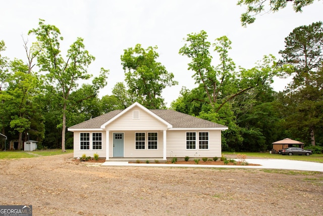 1920 Darling Ave, Waycross, GA 31501 - ranch-style house featuring a storage unit, a shingled roof, and covered porch