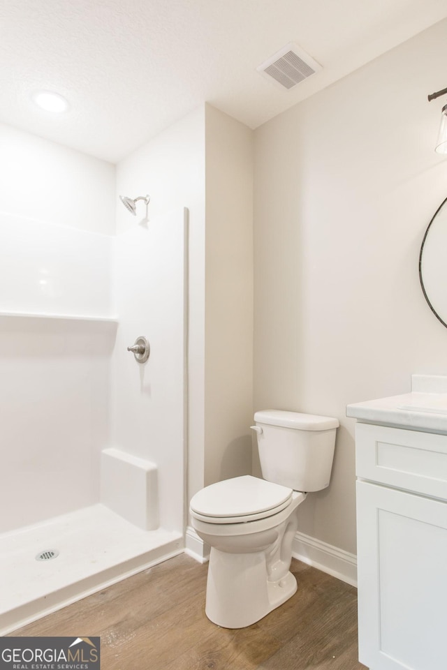 1920 Darling Ave, Waycross, GA 31501 - bathroom featuring vanity, wood finished floors, and a shower