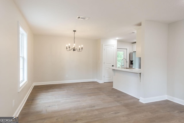 1920 Darling Ave, Waycross, GA 31501 - unfurnished dining area featuring a chandelier and light wood-style flooring