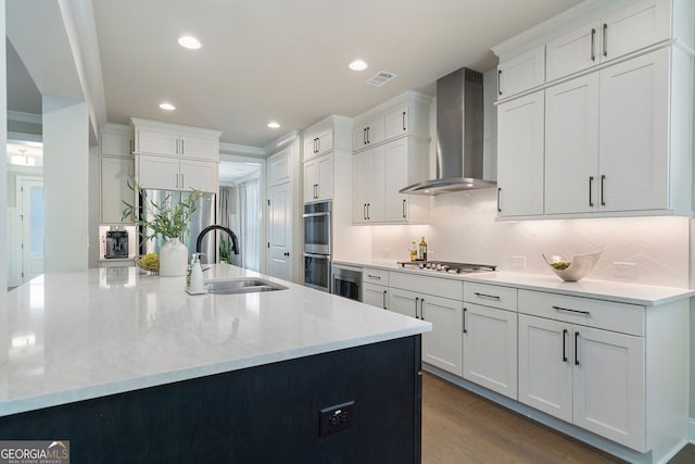 510 Walden Glen Ln, Alpharetta, GA 30004 - kitchen with wall chimney exhaust hood, appliances with stainless steel finishes, white cabinetry, tasteful backsplash, and recessed lighting