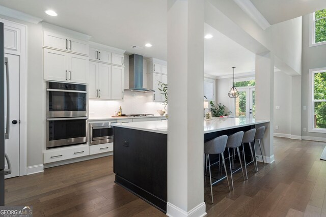 510 Walden Glen Ln, Alpharetta, GA 30004 - kitchen featuring wall chimney exhaust hood, appliances with stainless steel finishes, dark wood-type flooring, light countertops, and recessed lighting