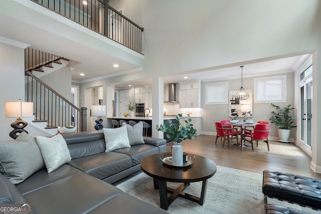 510 Walden Glen Ln, Alpharetta, GA 30004 - living room featuring light wood-style floors, crown molding, stairs, a high ceiling, and recessed lighting