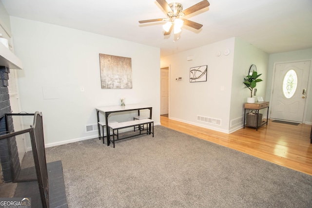 109 Susie Pl, Newnan, GA 30265 - living area with ceiling fan, a fireplace, carpet flooring, and wood finished floors