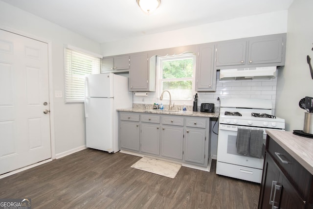 109 Susie Pl, Newnan, GA 30265 - kitchen featuring white appliances, gray cabinetry, under cabinet range hood, and tasteful backsplash