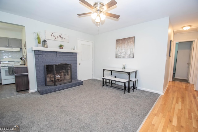 109 Susie Pl, Newnan, GA 30265 - carpeted living room with ceiling fan, a fireplace, and wood finished floors