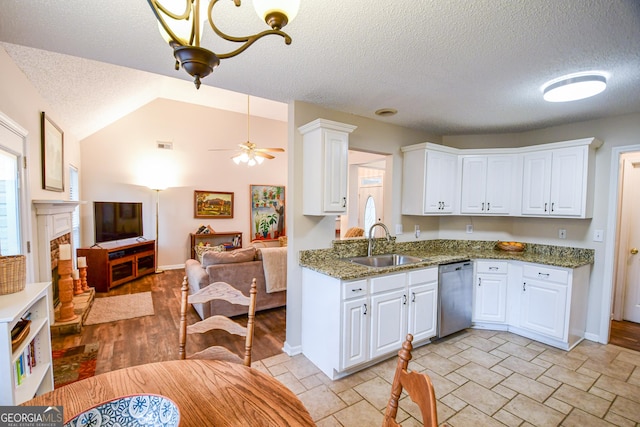 17 Kingsbrook Ln, Newnan, GA 30265 - kitchen featuring dishwasher, open floor plan, white cabinets, healthy amount of natural light, and a textured ceiling
