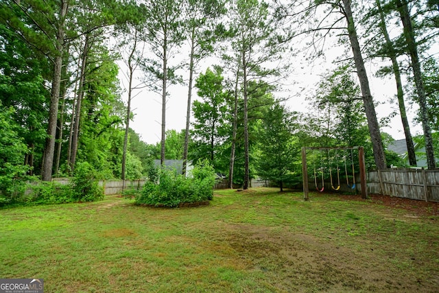 17 Kingsbrook Ln, Newnan, GA 30265 - fenced backyard with a playground