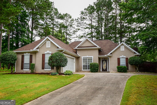 17 Kingsbrook Ln, Newnan, GA 30265 - traditional-style home featuring concrete driveway, stucco siding, an attached garage, a front yard, and roof with shingles