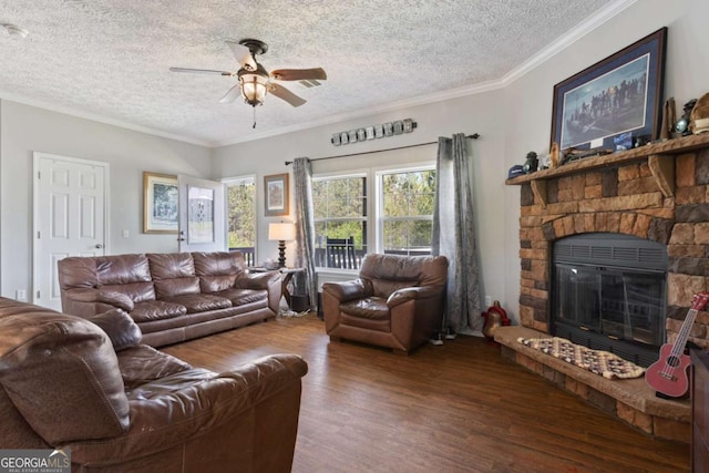 1641 Garland Mountain Trl, Waleska, GA 30183 - living room with wood finished floors, a textured ceiling, a ceiling fan, a stone fireplace, and crown molding