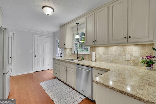 2095 Honeysuckle Dr, Cumming, GA 30040 - kitchen featuring stainless steel dishwasher, freestanding refrigerator, ornamental molding, light wood-style flooring, and hanging light fixtures