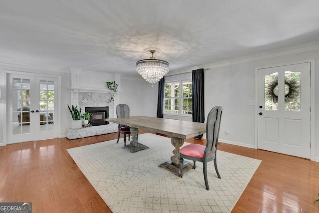 2095 Honeysuckle Dr, Cumming, GA 30040 - dining space featuring healthy amount of natural light, wood finished floors, french doors, and crown molding