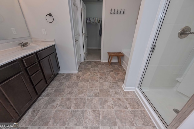 110 Serendipity Way, Dallas, GA 30157 - full bathroom with a shower stall, vanity, a walk in closet, and stone finish flooring