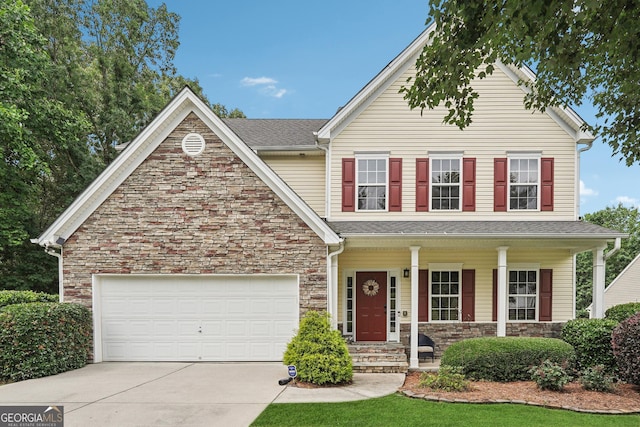 6521 Boulder Crest Ct, Flowery Branch, GA 30542 - view of front of home with stone siding, driveway, a porch, and a garage