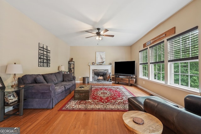 6521 Boulder Crest Ct, Flowery Branch, GA 30542 - living area with ceiling fan, wood finished floors, and a stone fireplace