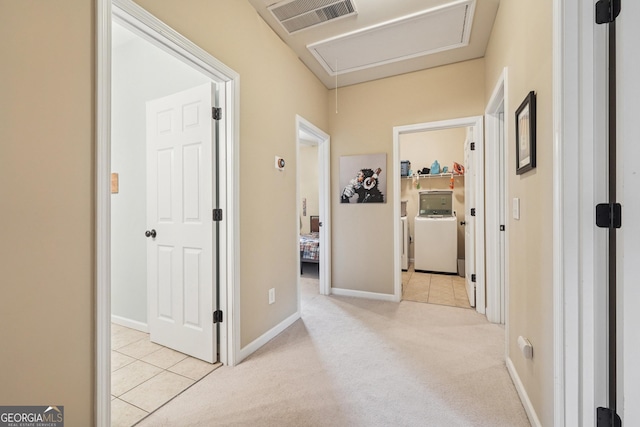 6521 Boulder Crest Ct, Flowery Branch, GA 30542 - corridor with washer / clothes dryer, attic access, light tile patterned floors, and light colored carpet