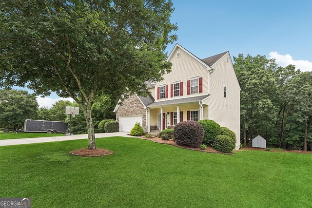 6521 Boulder Crest Ct, Flowery Branch, GA 30542 - traditional-style home featuring concrete driveway, covered porch, a shed, and a front yard