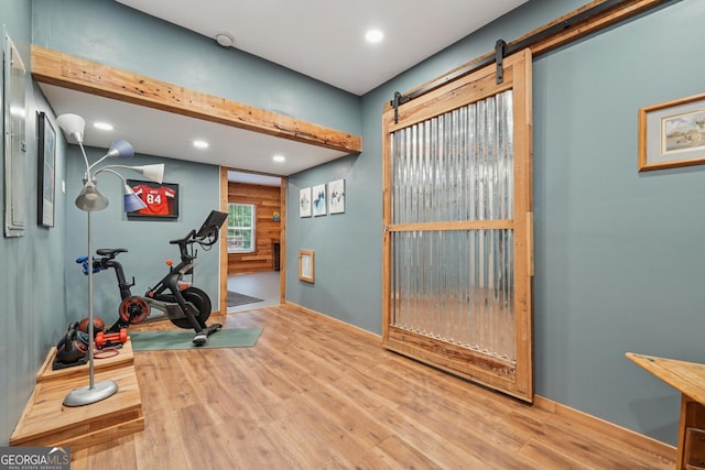 6521 Boulder Crest Ct, Flowery Branch, GA 30542 - workout area with wood finished floors, recessed lighting, and a barn door