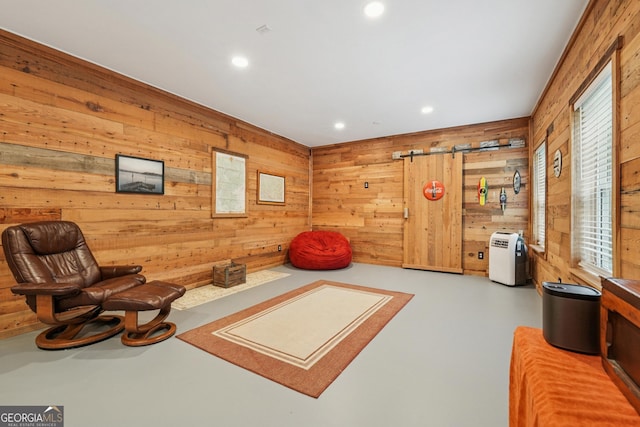 6521 Boulder Crest Ct, Flowery Branch, GA 30542 - sitting room featuring wood walls, finished concrete flooring, recessed lighting, and a barn door