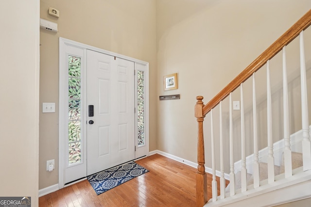 6521 Boulder Crest Ct, Flowery Branch, GA 30542 - entrance foyer with wood-type flooring, stairway, and a towering ceiling