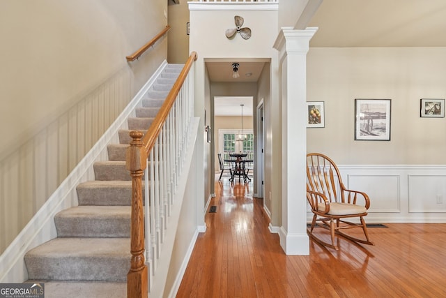 6521 Boulder Crest Ct, Flowery Branch, GA 30542 - stairway featuring hardwood / wood-style flooring and ornate columns