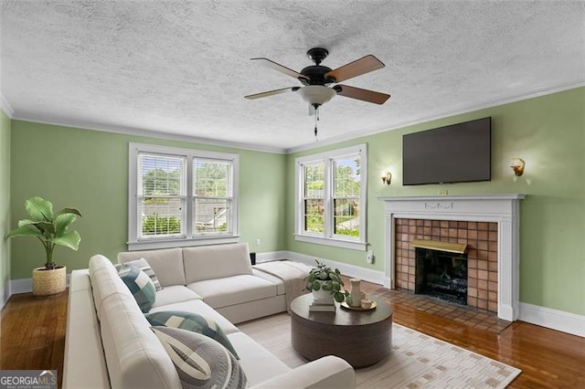 303 Hardee St, Dallas, GA 30132 - living room with ceiling fan, crown molding, plenty of natural light, wood finished floors, and a tiled fireplace