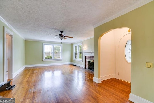 303 Hardee St, Dallas, GA 30132 - unfurnished living room featuring a ceiling fan, wood finished floors, a fireplace, a textured ceiling, and ornamental molding