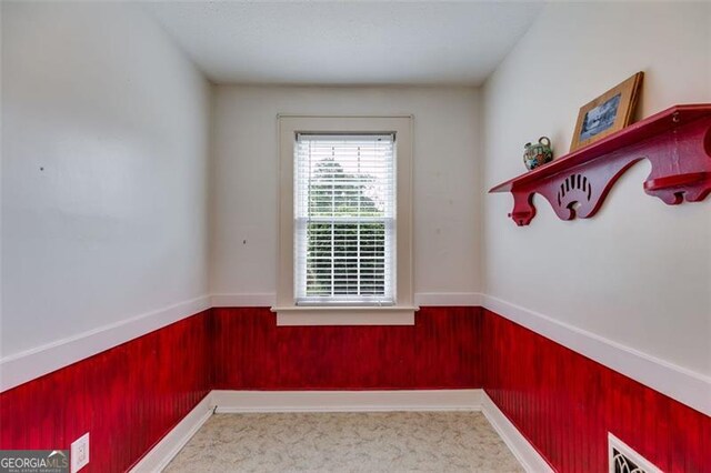 303 Hardee St, Dallas, GA 30132 - empty room featuring wainscoting, wooden walls, and carpet flooring