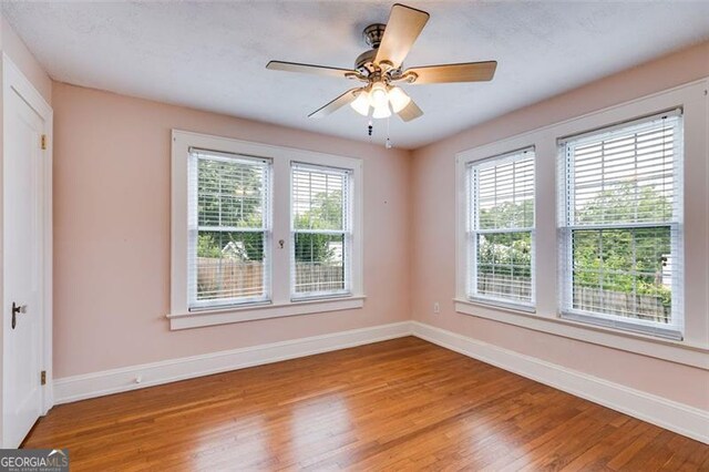 303 Hardee St, Dallas, GA 30132 - empty room with wood finished floors and a ceiling fan