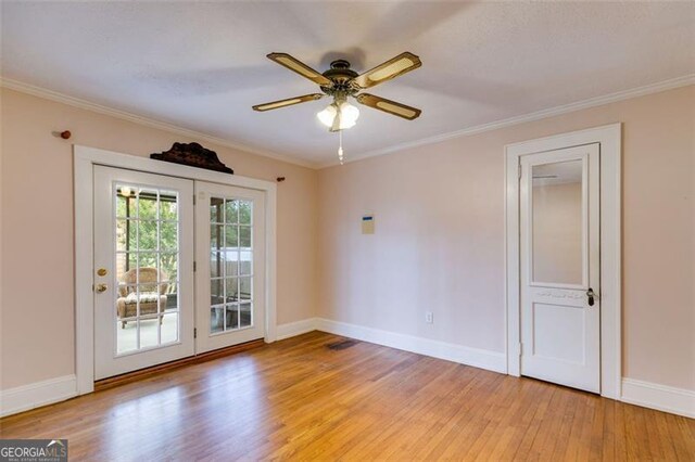 303 Hardee St, Dallas, GA 30132 - empty room with light wood-style flooring, a ceiling fan, and crown molding
