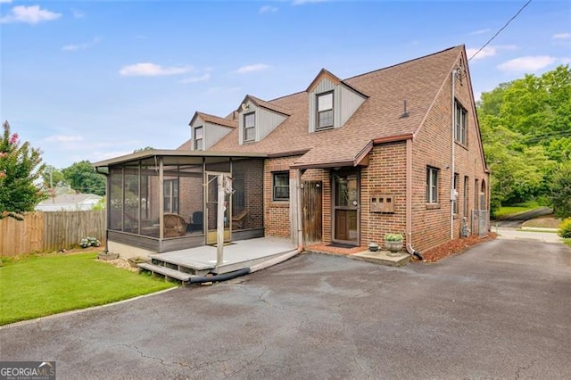 303 Hardee St, Dallas, GA 30132 - cape cod-style house featuring a sunroom, brick siding, and a shingled roof