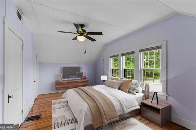 303 Hardee St, Dallas, GA 30132 - bedroom with vaulted ceiling, wood finished floors, and a ceiling fan