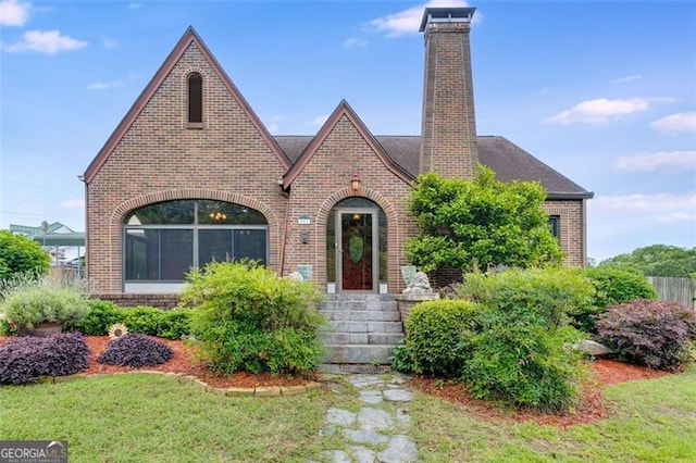 303 Hardee St, Dallas, GA 30132 - tudor-style house with brick siding, a chimney, and a front lawn