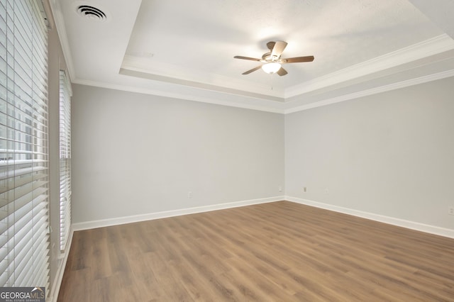 40 Springwater Chase, Newnan, GA 30265 - empty room with a raised ceiling, ceiling fan, wood finished floors, and crown molding