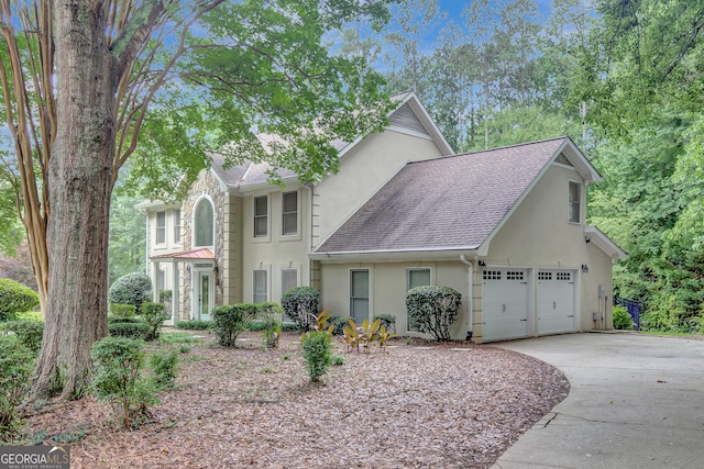40 Springwater Chase, Newnan, GA 30265 - view of front of home with stucco siding, roof with shingles, and driveway