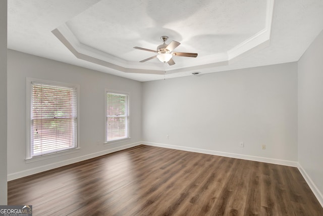 40 Springwater Chase, Newnan, GA 30265 - empty room featuring a tray ceiling, ornamental molding, dark wood-style flooring, and a ceiling fan