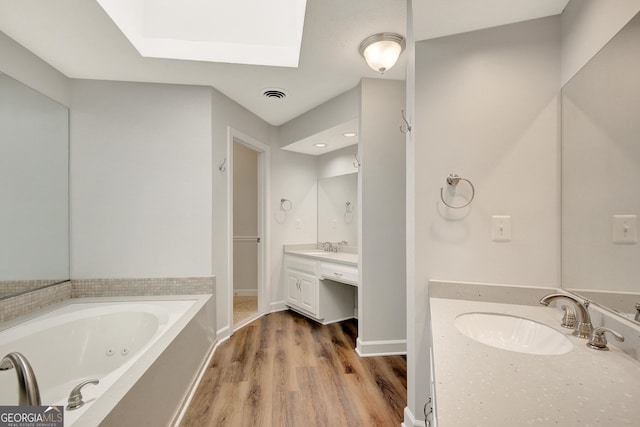 40 Springwater Chase, Newnan, GA 30265 - bathroom with a skylight, vanity, a whirlpool tub, and wood finished floors