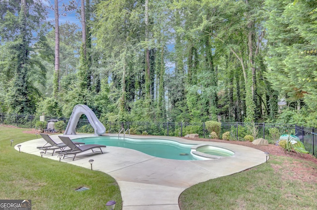 40 Springwater Chase, Newnan, GA 30265 - view of swimming pool with a water slide, a fenced backyard, a patio area, a pool with connected hot tub, and a forest view