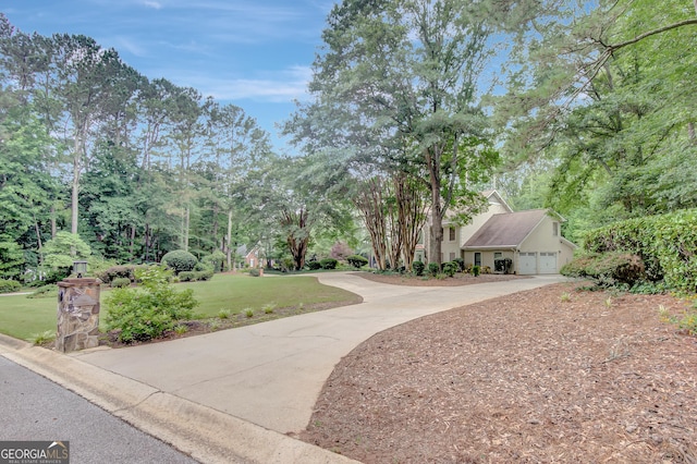 40 Springwater Chase, Newnan, GA 30265 - view of home's community featuring concrete driveway, a yard, an attached garage, and view of scattered trees