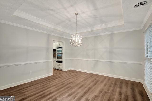 40 Springwater Chase, Newnan, GA 30265 - unfurnished dining area featuring a raised ceiling, wood finished floors, crown molding, and a chandelier