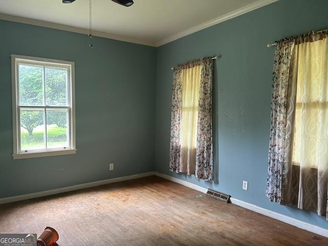 680 Thomas Rd, Trion, GA 30753 - empty room featuring healthy amount of natural light, wood finished floors, crown molding, and ceiling fan
