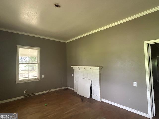 680 Thomas Rd, Trion, GA 30753 - unfurnished living room featuring ornamental molding, dark wood-type flooring, and a fireplace with flush hearth