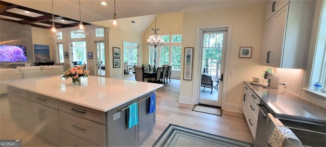 1330 Jackson Ridge Rd, Greensboro, GA 30642 - kitchen with gray cabinets, light countertops, light wood-style floors, a chandelier, and hanging light fixtures