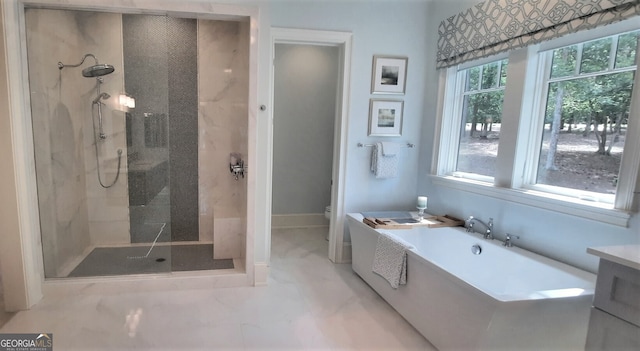 1330 Jackson Ridge Rd, Greensboro, GA 30642 - bathroom featuring a freestanding tub, marble finish floors, and tiled shower