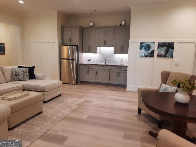 1330 Jackson Ridge Rd, Greensboro, GA 30642 - living room featuring a wainscoted wall, light wood-type flooring, a decorative wall, crown molding, and recessed lighting